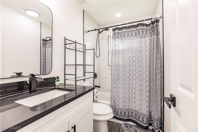 full bathroom featuring shower / bathtub combination with curtain, wood-type flooring, vanity, and toilet