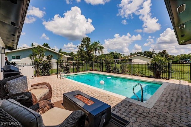 view of swimming pool with area for grilling and a patio area