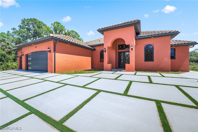 mediterranean / spanish house with a garage