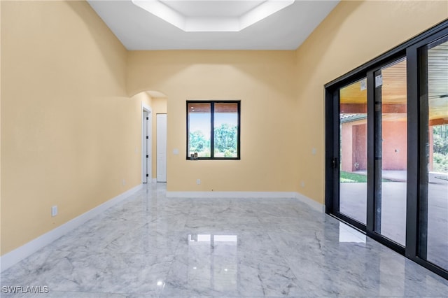 empty room featuring a tray ceiling