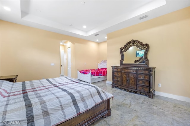 bedroom with a raised ceiling