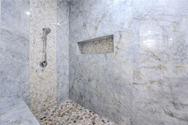 bathroom with a tile shower