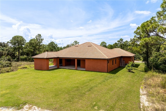 rear view of house featuring a yard