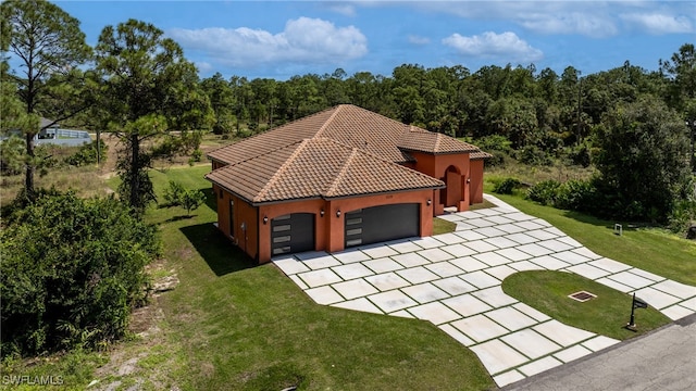 view of front of property with a front yard and a garage