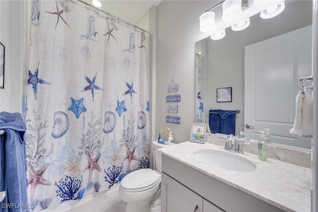 bathroom featuring toilet and vanity