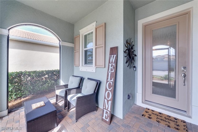 entrance to property featuring stucco siding