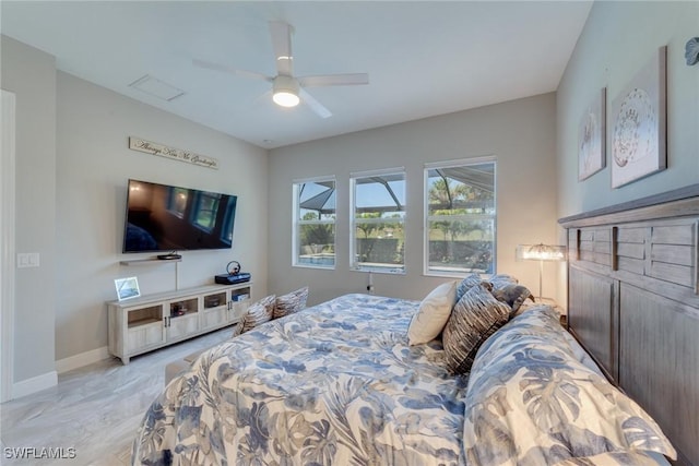 bedroom featuring a ceiling fan and baseboards