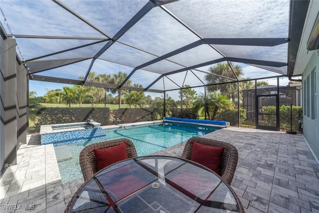 view of swimming pool featuring a lanai, a patio area, and a pool with connected hot tub