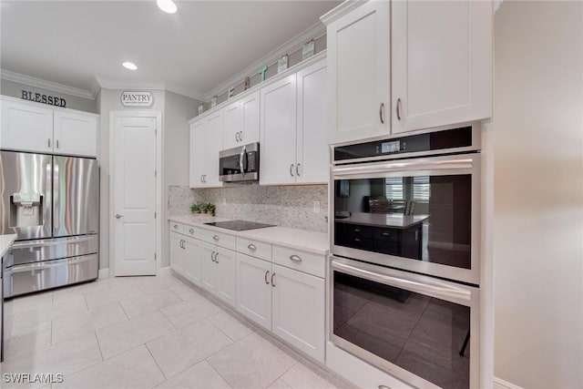 kitchen featuring white cabinetry, light countertops, ornamental molding, appliances with stainless steel finishes, and backsplash