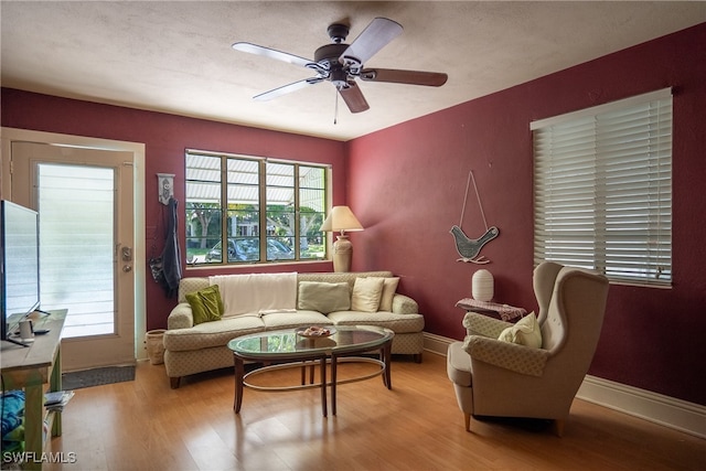 living room featuring light hardwood / wood-style floors and ceiling fan