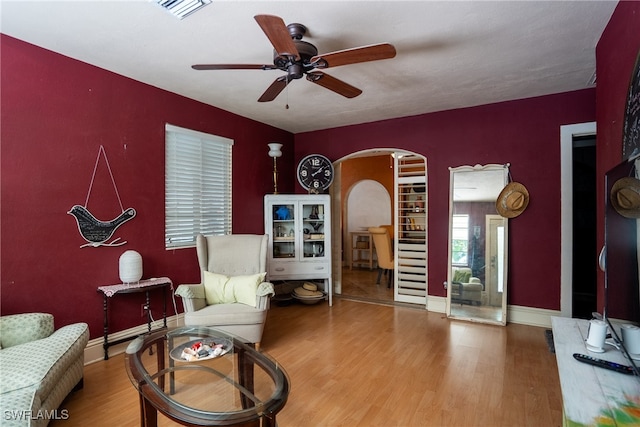 living area featuring ceiling fan and hardwood / wood-style flooring