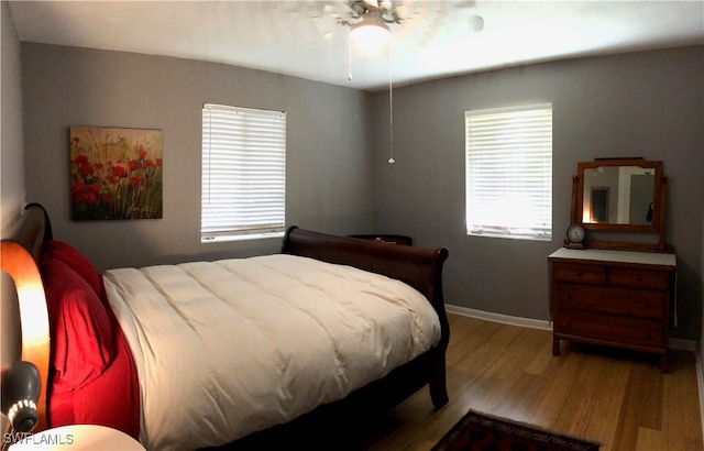 bedroom with light wood-type flooring and ceiling fan