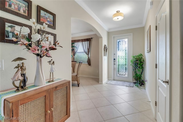 tiled entryway featuring crown molding