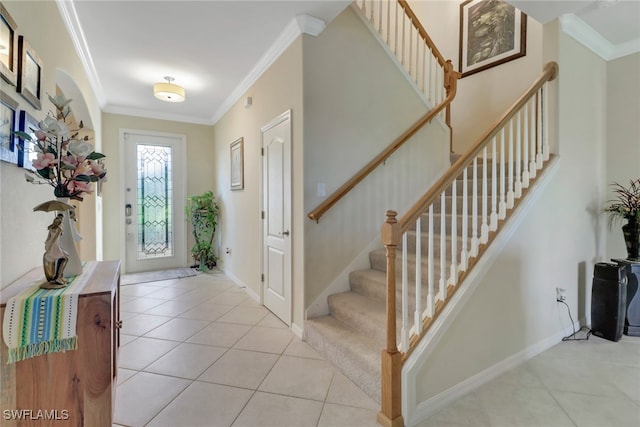 entryway featuring ornamental molding and light tile patterned floors