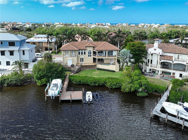 dock area with a water view and a balcony