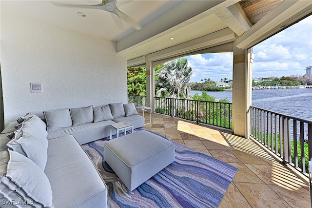 exterior space featuring an outdoor hangout area, a water view, and ceiling fan