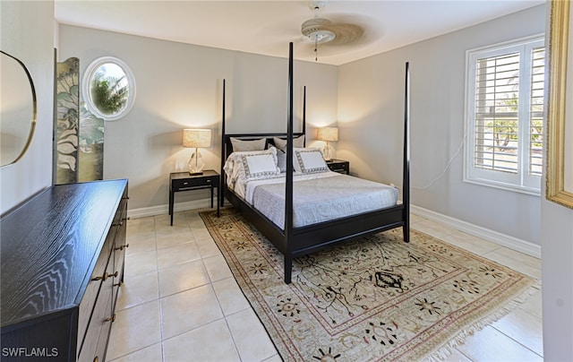 bedroom with multiple windows, light tile patterned floors, and ceiling fan