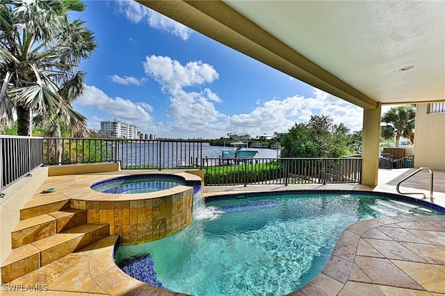 view of pool with a patio, an in ground hot tub, a water view, and pool water feature