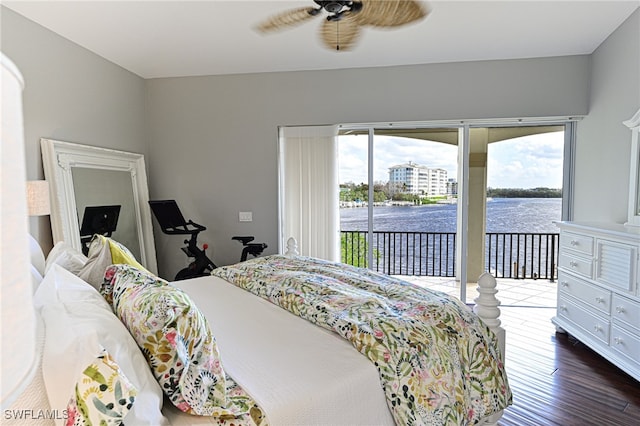 bedroom featuring access to exterior, dark wood-type flooring, a water view, and ceiling fan