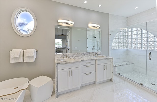 bathroom featuring a shower with shower door and vanity