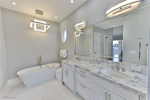 bathroom with vanity, a tub to relax in, and a wealth of natural light