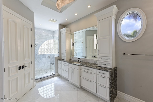 bathroom featuring tiled shower and vanity