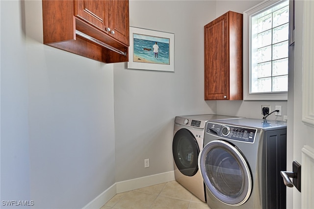 laundry room featuring cabinets, independent washer and dryer, and light tile patterned flooring