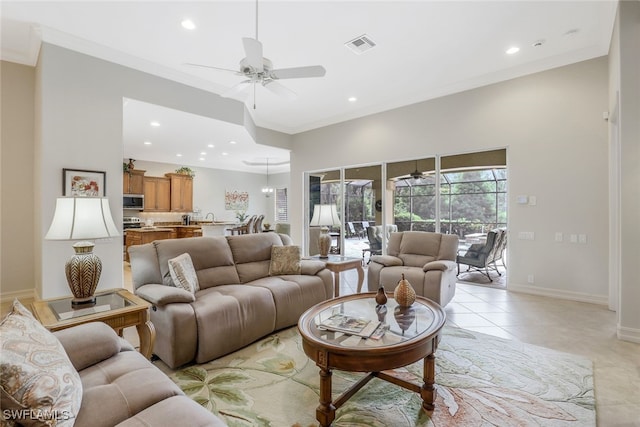 tiled living room featuring ceiling fan and ornamental molding