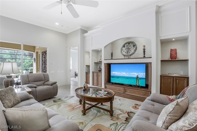 living room with built in shelves, crown molding, and ceiling fan