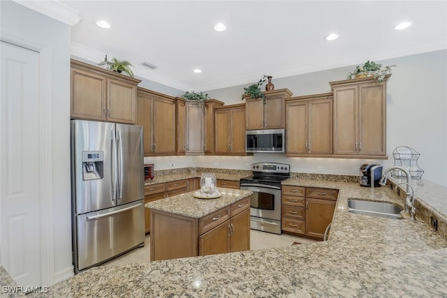 kitchen featuring crown molding, sink, light stone countertops, appliances with stainless steel finishes, and kitchen peninsula