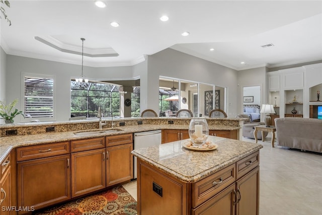 kitchen with sink, an inviting chandelier, light stone counters, stainless steel dishwasher, and ornamental molding