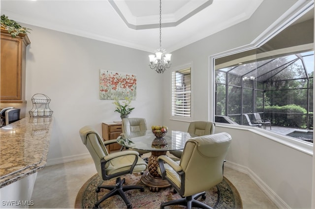 dining room featuring a raised ceiling, crown molding, and a notable chandelier