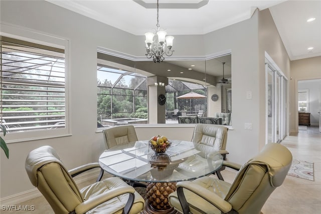 tiled dining area with an inviting chandelier, plenty of natural light, and ornamental molding