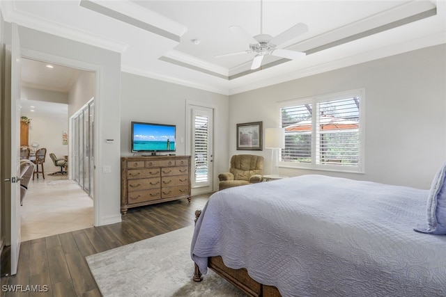 bedroom with ceiling fan, a raised ceiling, and crown molding