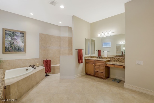 bathroom featuring tile patterned floors, tiled tub, and vanity