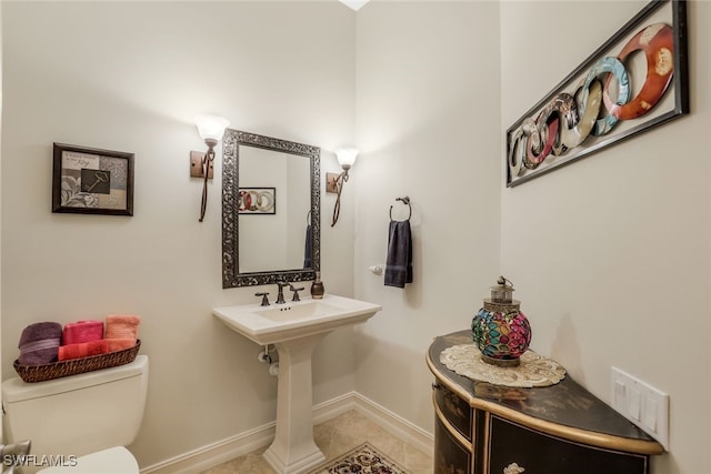 bathroom with tile patterned flooring and toilet