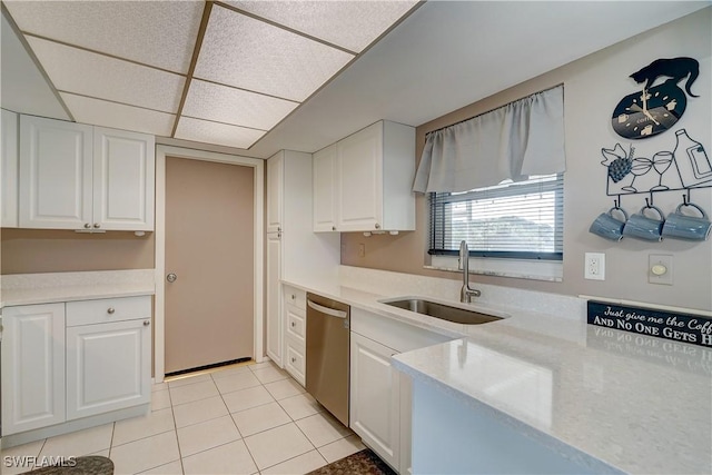 kitchen featuring a drop ceiling, dishwasher, white cabinets, and sink