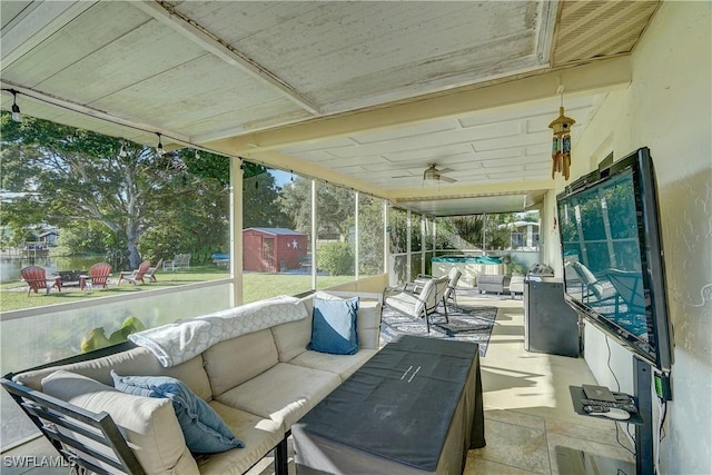 sunroom / solarium featuring ceiling fan