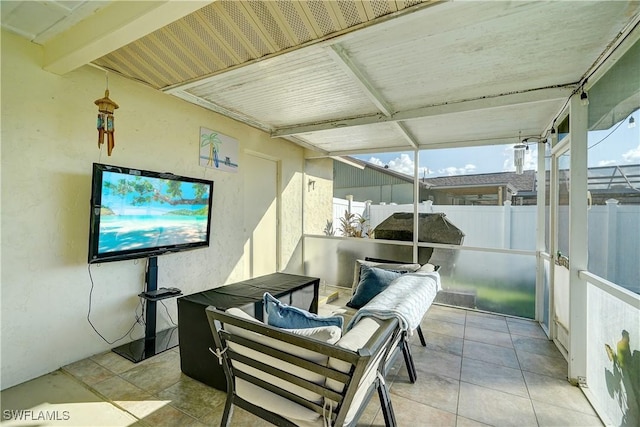 sunroom with beamed ceiling