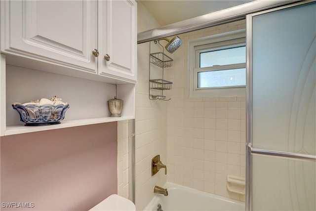 bathroom with enclosed tub / shower combo and toilet