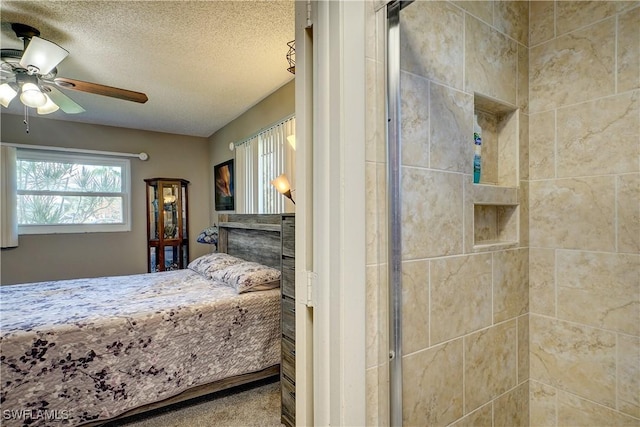 bedroom featuring ceiling fan and a textured ceiling