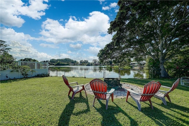 view of yard featuring a water view and an outdoor fire pit