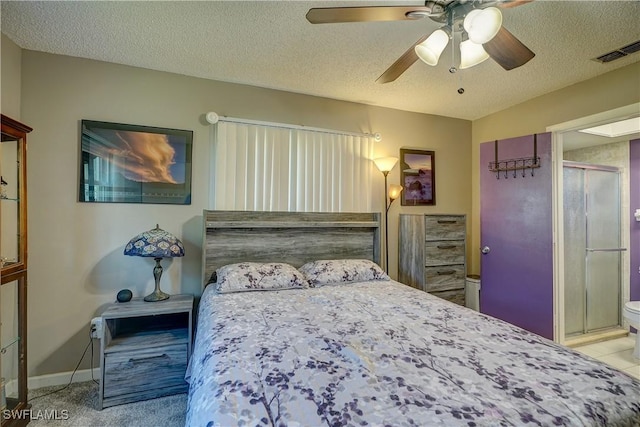 bedroom featuring ceiling fan, light colored carpet, and a textured ceiling