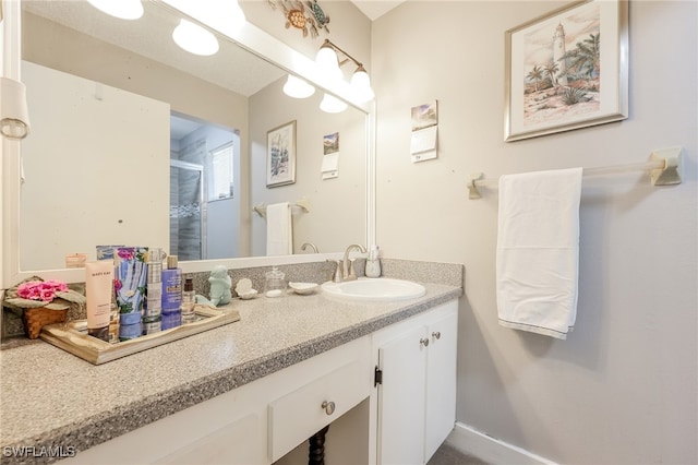 bathroom featuring walk in shower and vanity