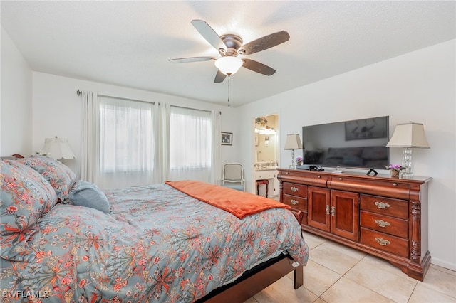 tiled bedroom featuring connected bathroom and ceiling fan