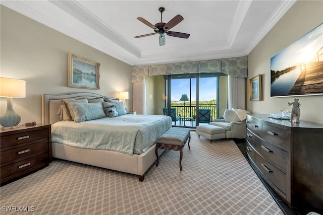 bedroom with crown molding, ceiling fan, access to exterior, a tray ceiling, and light carpet