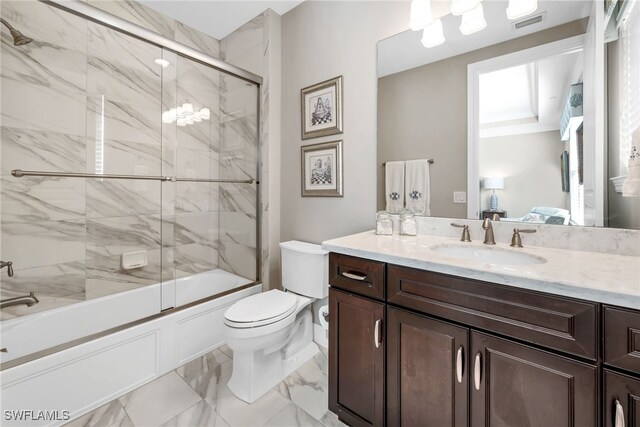 full bathroom featuring vanity, toilet, and combined bath / shower with glass door