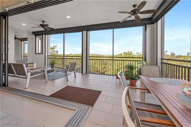 sunroom featuring ceiling fan