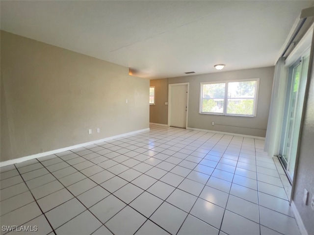 unfurnished room with light tile patterned floors