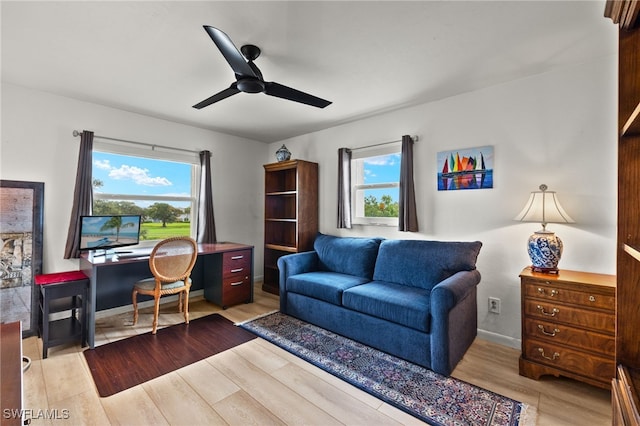 office featuring light wood-type flooring, plenty of natural light, and ceiling fan